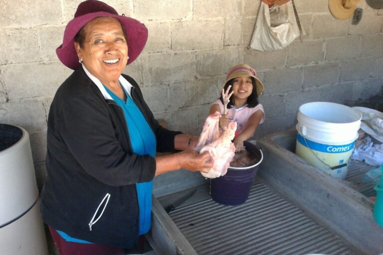 Flora passes down the tradition and love of cooking to her granddaughter, Briana. Here, they are breaking down the turkey to make mole.